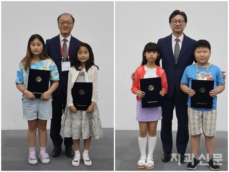 신동열 부회장(좌)과 구강보건의날 준비위원장인 조정근 부회장(우)이 치아 그리기 대회 수상자에게 상장을 전달했다.